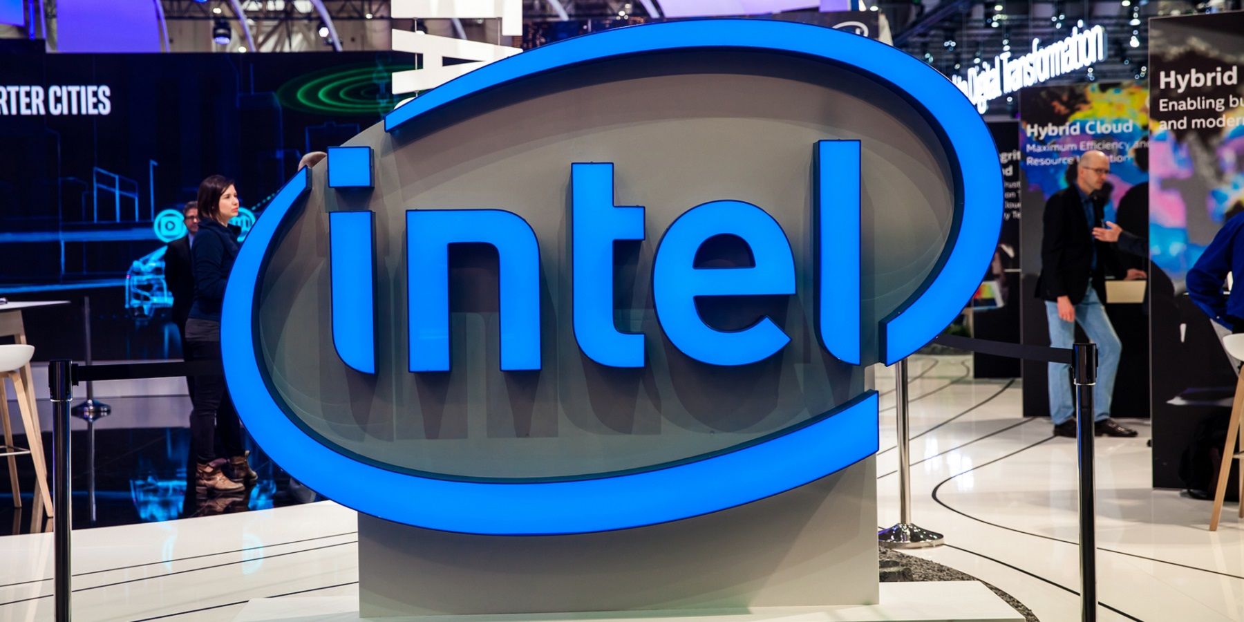 Photo of the Intel logo in the foreground of a convention.