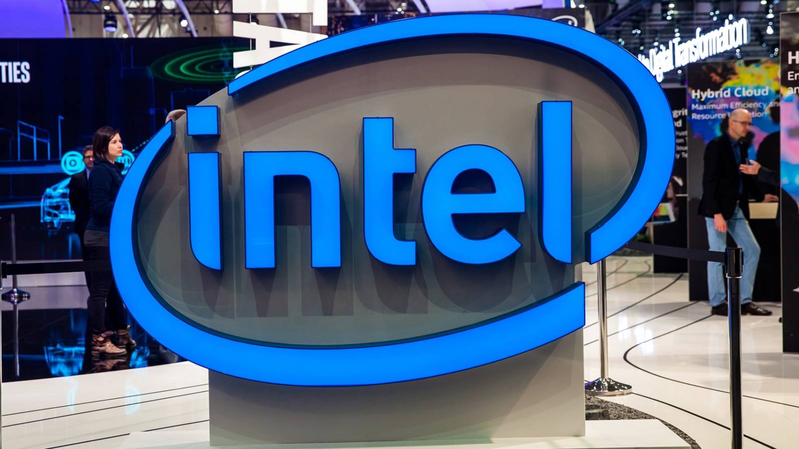 Photo of the Intel logo in the foreground of a convention.