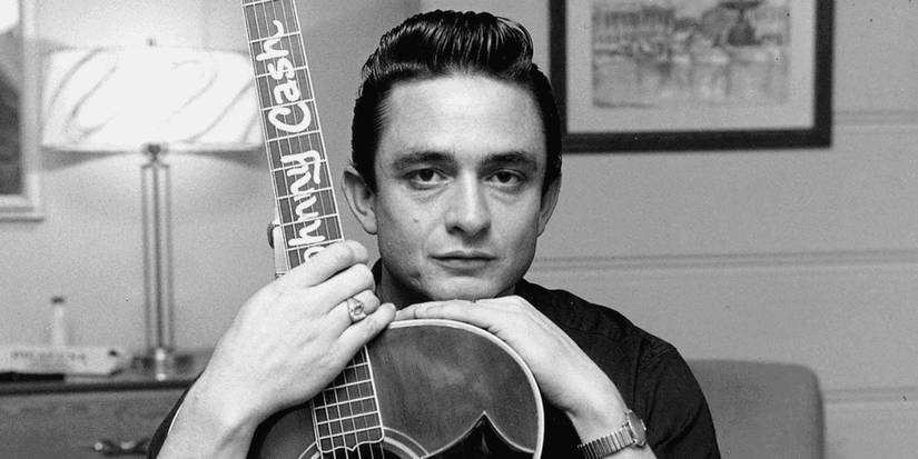 An image of the singer Johnny Cash holding a guitar.