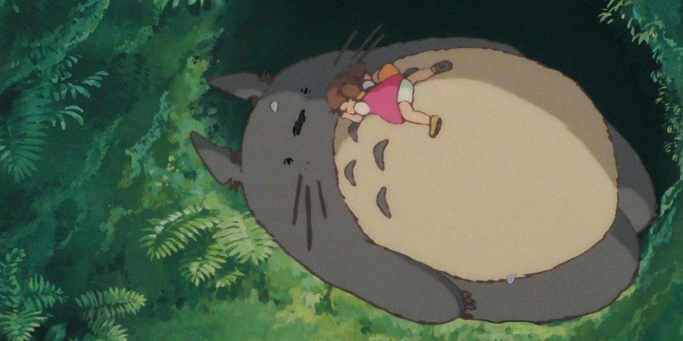Little girl sleeping on Totoro. 