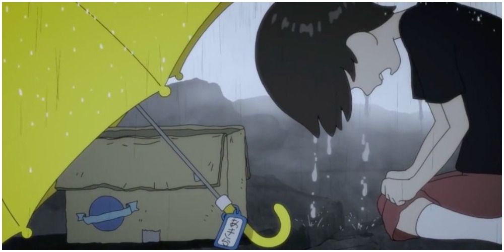 Little Akira crying over box in rain. 