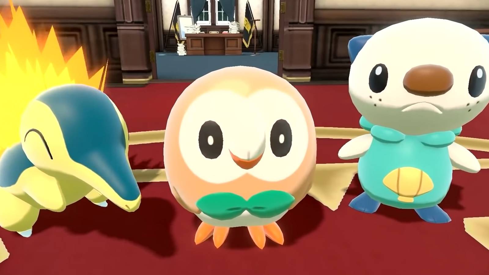 Cyndaquil, Rowlett, and Oshawott stand in a drawing room