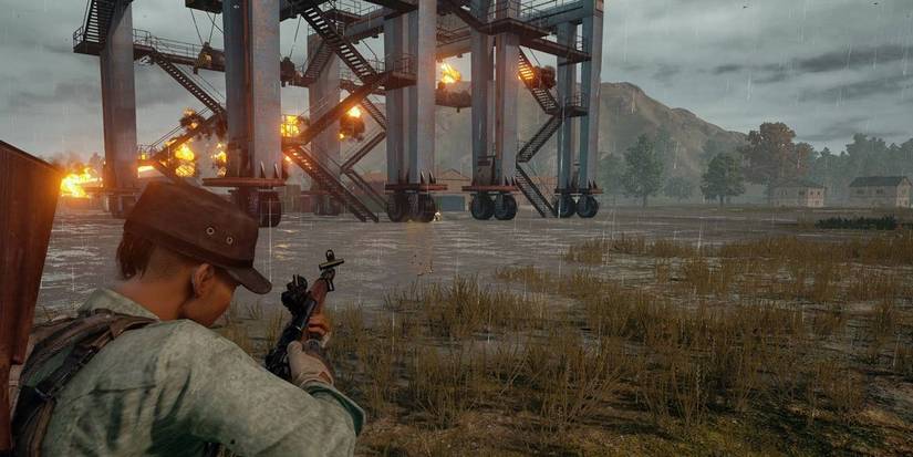 pubg players shooting at a structure 