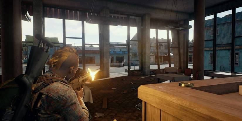 pubg players shooting at an enemy in cover 