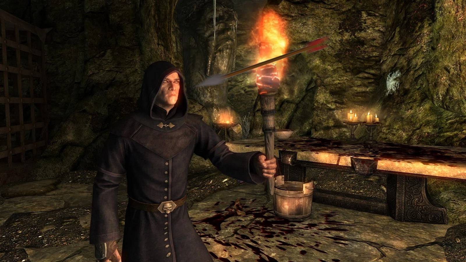 Image from Skyrim showing a necromancer holding a lit torch as an arrow flies towards their face.