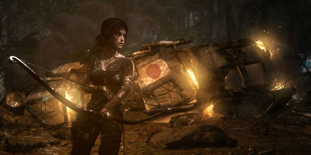 Lara Croft stands near the fiery wreck of a plane with her bow drawn 