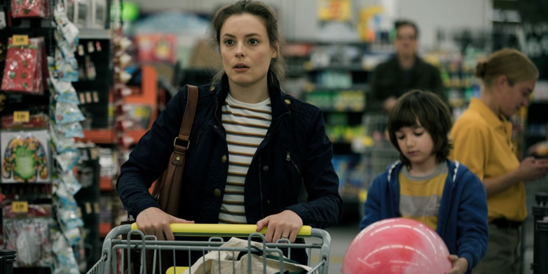 Gillian Jacobs as Sarah in a supermarket with Azhy Robertson as Oliver in Come Play
