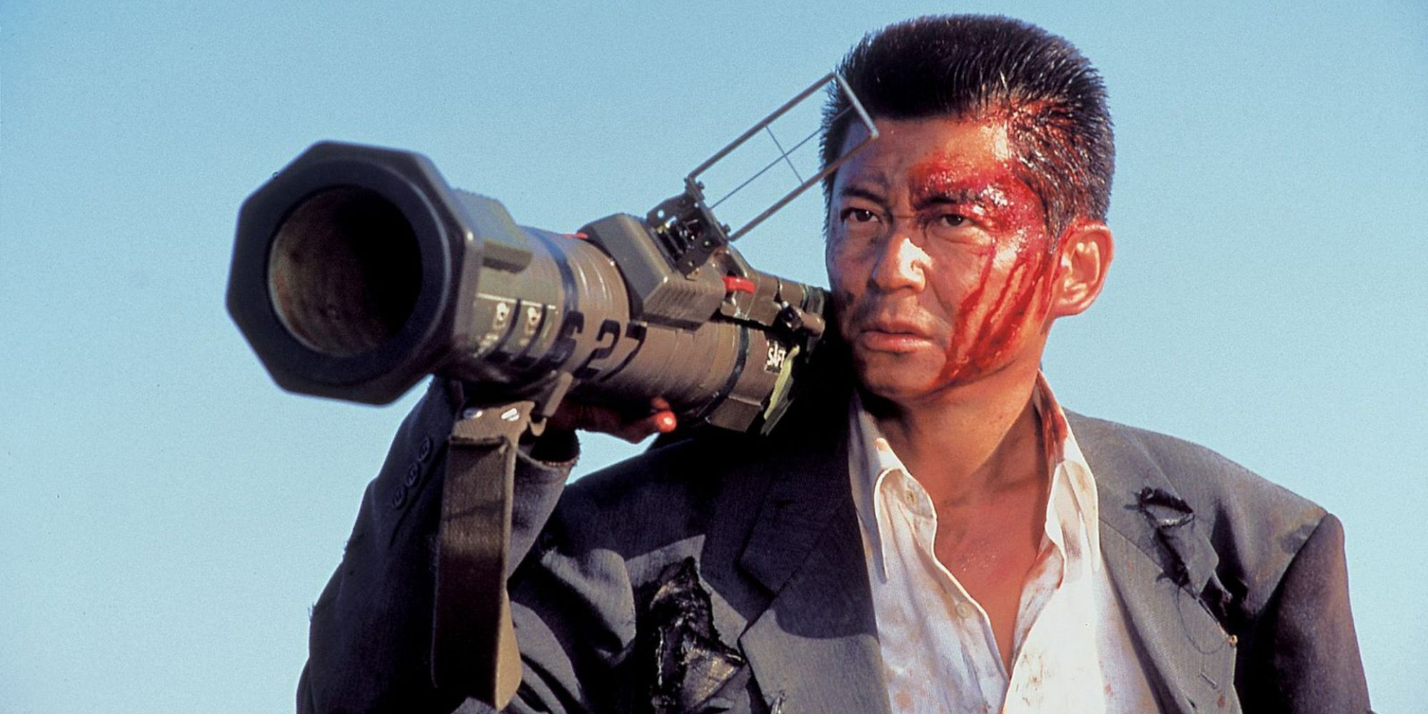 A bloodied man holds a rocket launcher in Dead or Alive