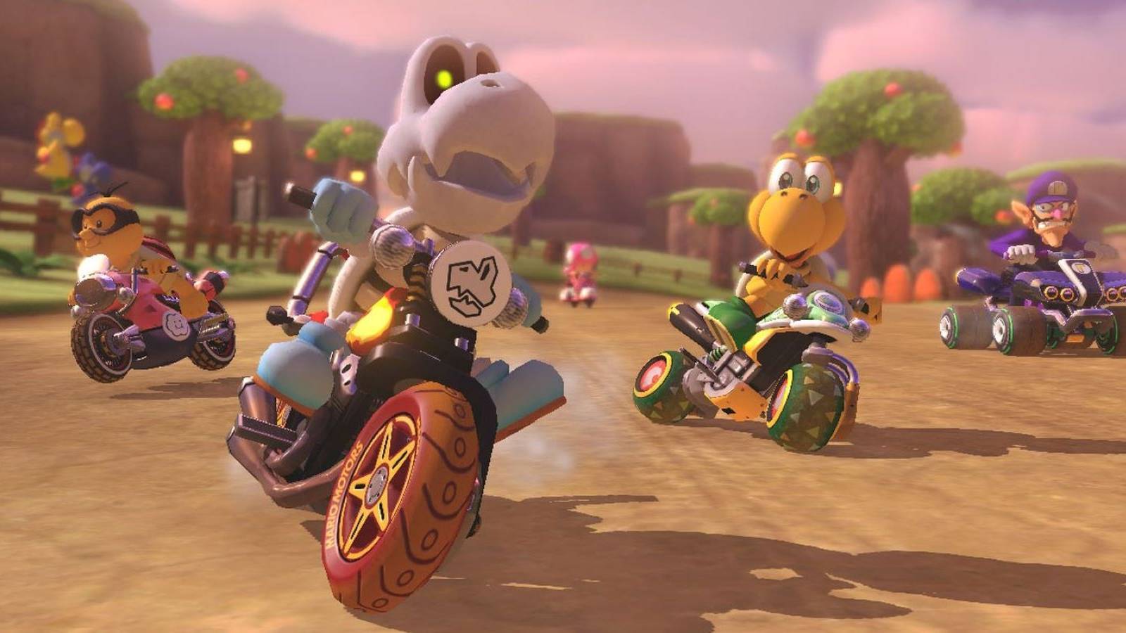 Lakitu, Dry Bones, Toadette, Koopa Troopa, and Waluigi driving on a Yoshi course in Mario Kart 8 Deluxe