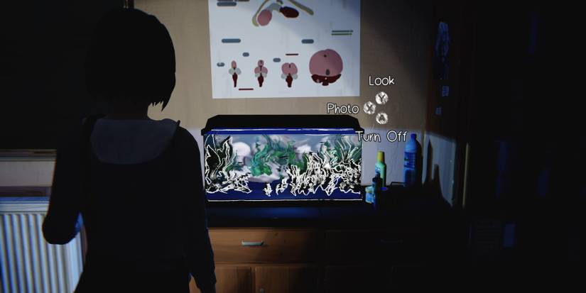 Max looking at a lit up fish tank at night, in the science classroom, during Episode 3 of Life is Strange Remastered
