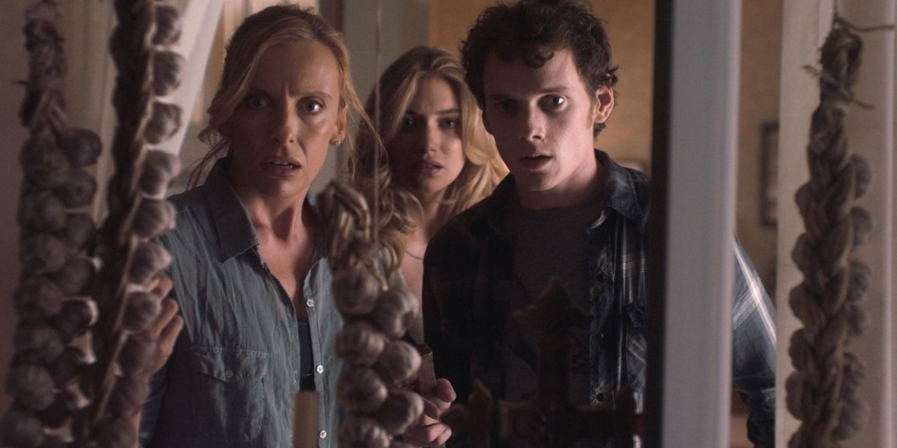Jane (Toni Collette), Amy (Imogen Poots) and Charley (Anton Yelchin) looking scared in Fright Night (2011)