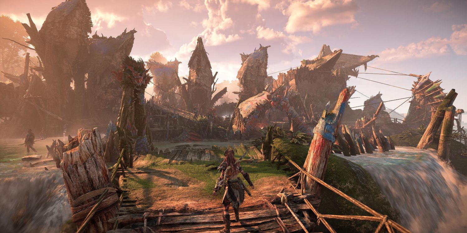aloy standing in the entrance of a small town with sharp, wooden buildings and twin waterfalls flanking the entrance