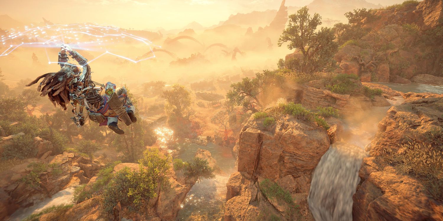 aloy gliding under a glowing blue shield past a series of waterfalls 