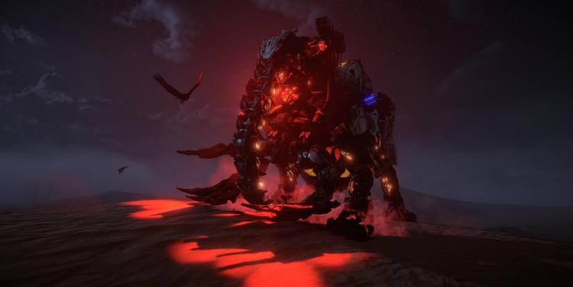 an elephant machine glowing red against sandy dunes at night 