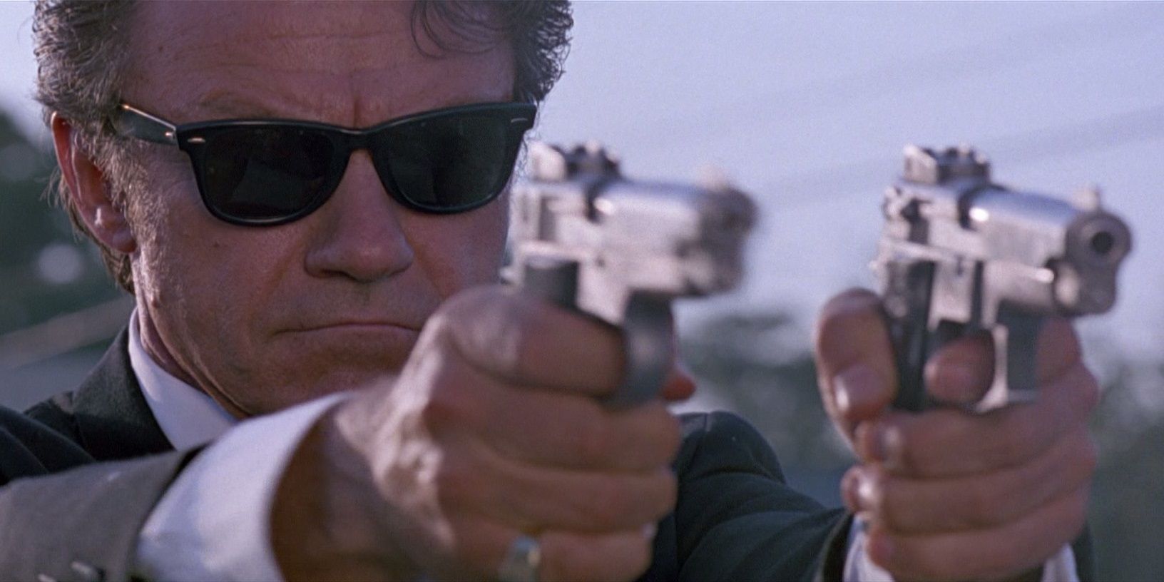 Harvey Keitel firing two handguns in Reservoir Dogs