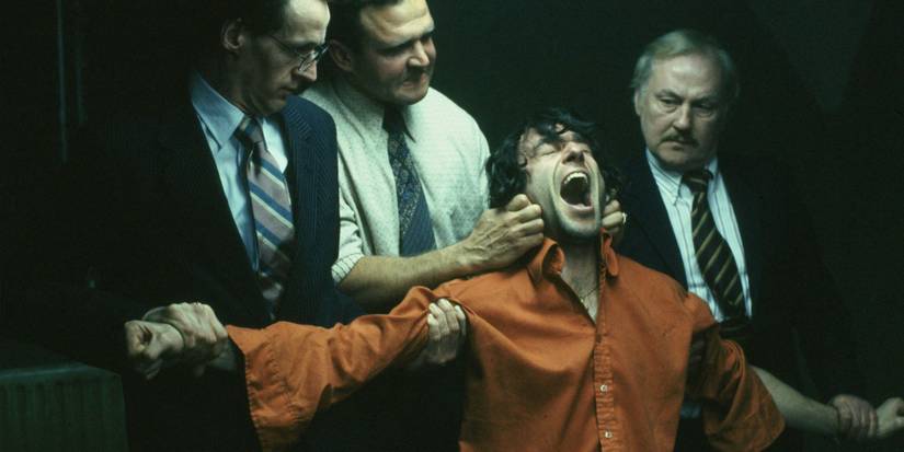 Three people restraining Daniel Day-Lewis's character In The Name Of The Father