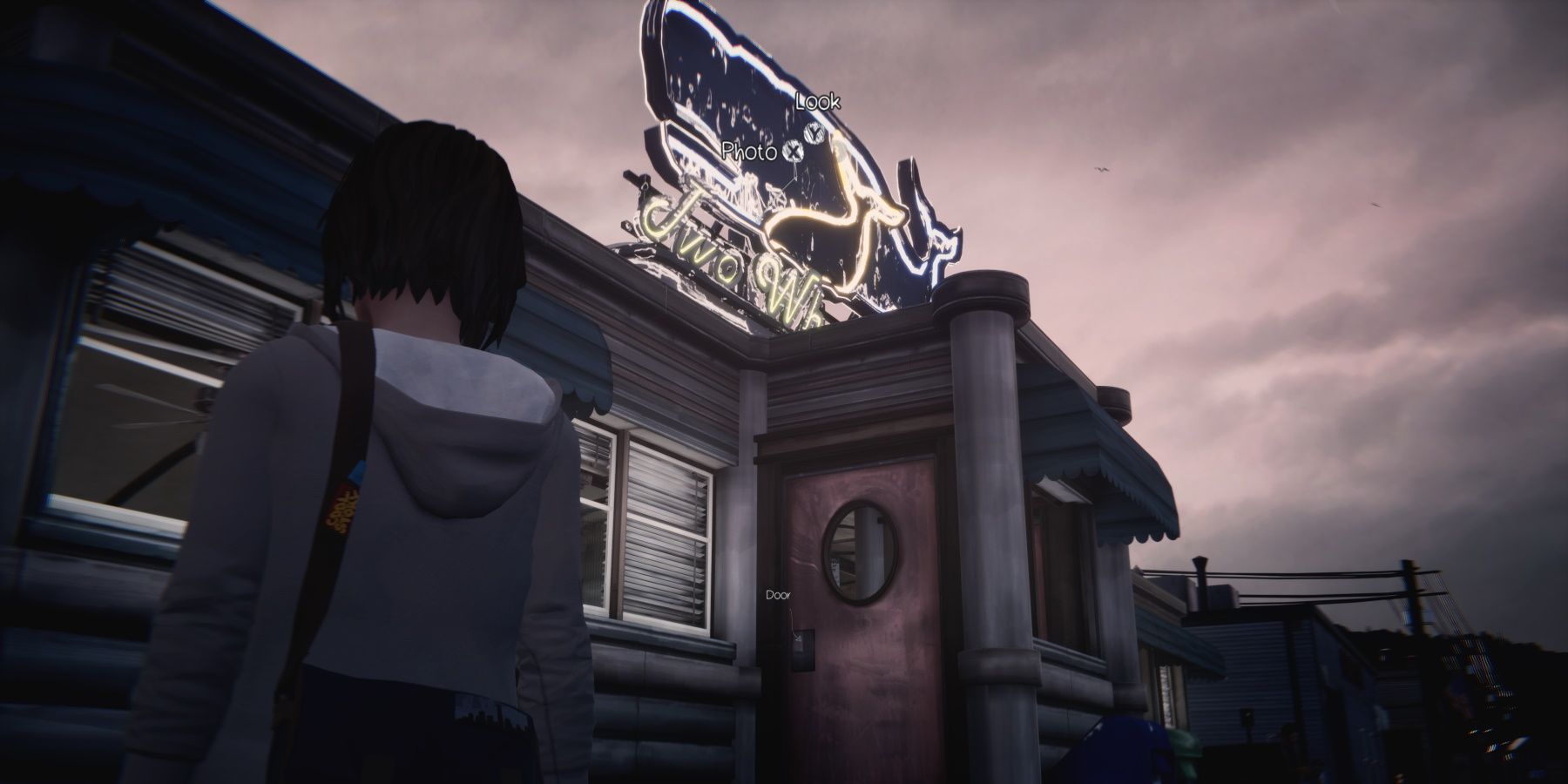 Max looking at two whales diner sign in epsidoe 2 of life is strange