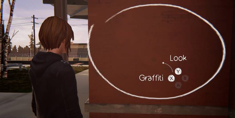 Chloe staring at a potential graffiti spot on a wall during Episode 1 of Life is Strange: Before the Storm Remastered