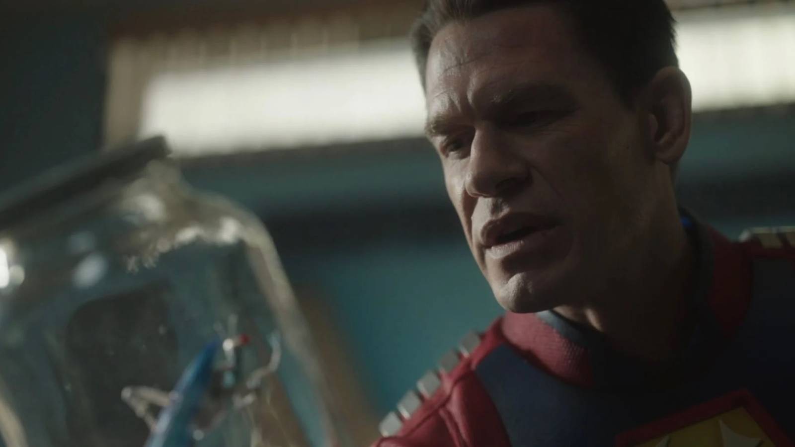 Peacemaker looking at a Butterfly in a jar