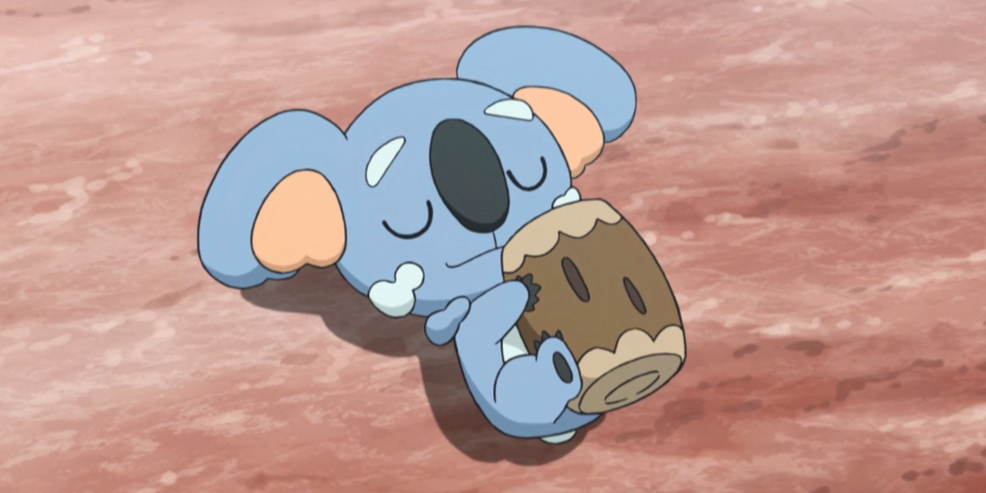 A Komala sleeping on the ground in the anime