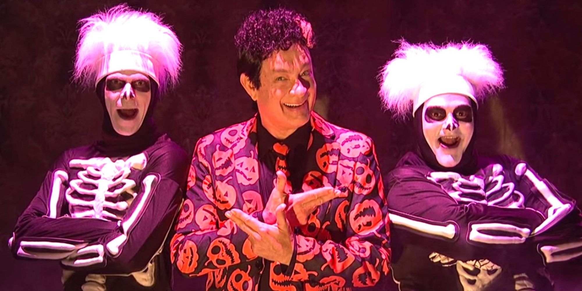 Tom Hanks as David S. Pumpkins, standing with Left Skeleton (Mikey Day) and Fat Skeleton (Bobby Moynihan)