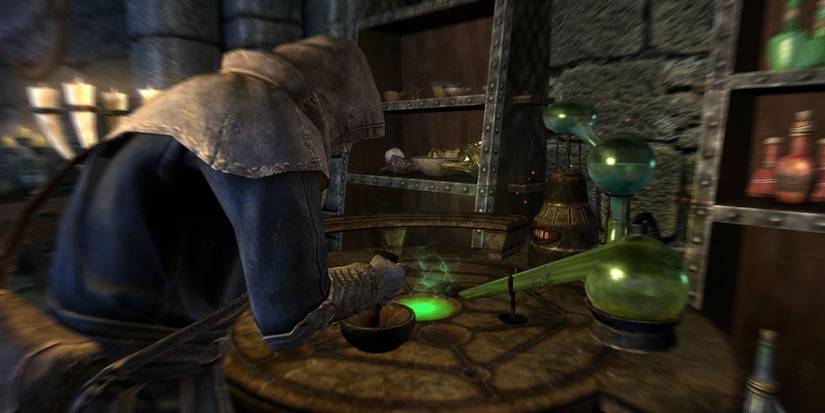 A player brews potions over an alchemy table in the RPG Elder Scrolls V: Skyrim