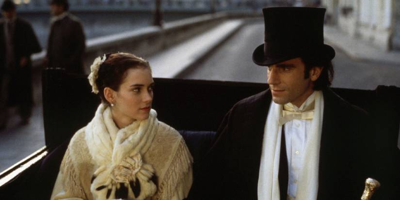Daniel Day-Lewis and his co-star riding in a carriage in The Age Of Innocence
