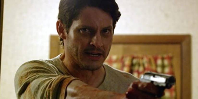 Ben (Stephen Brodie) in The Rake holding up a gun