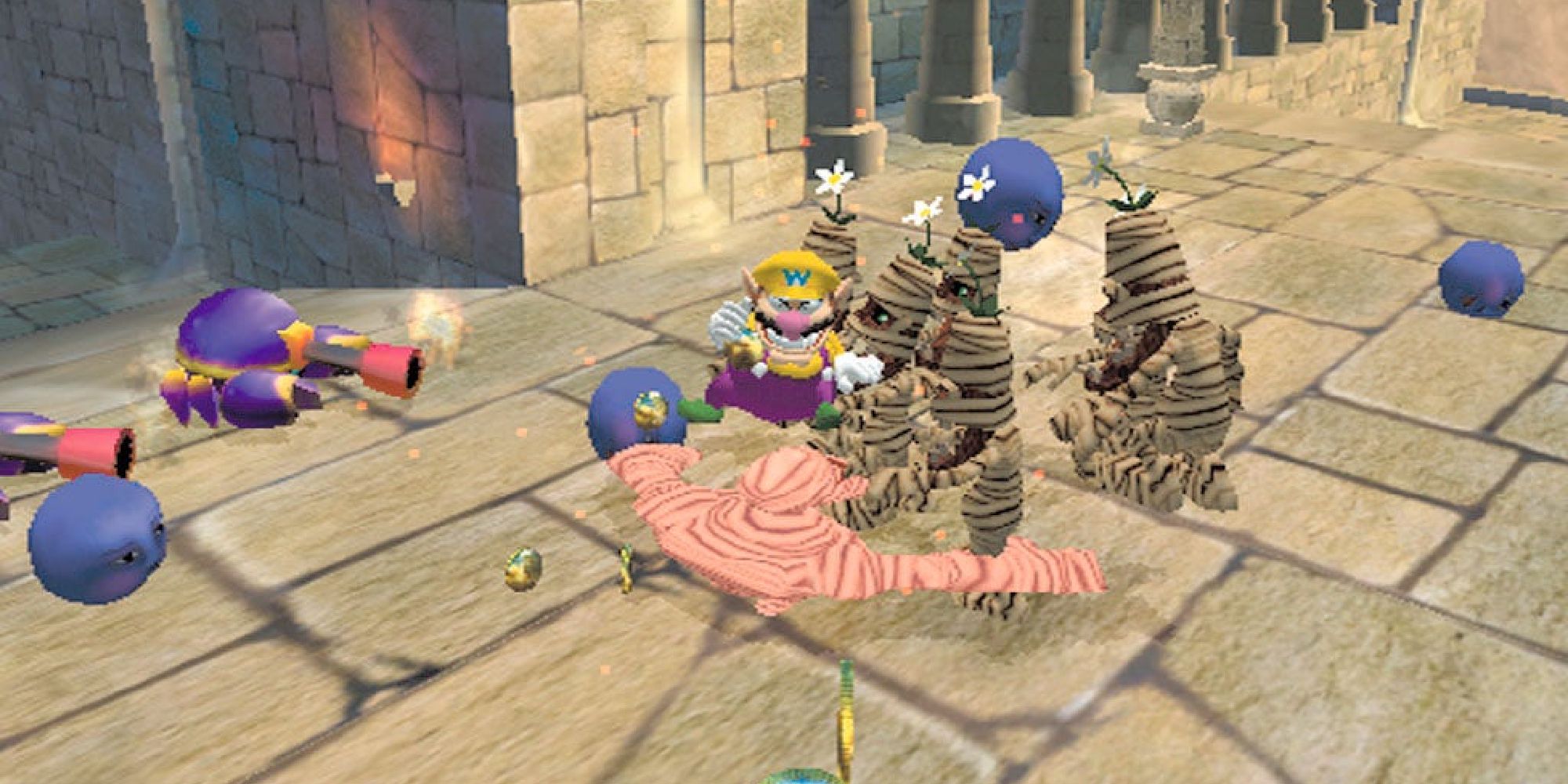 Wario surrounded by bug and mummy enemies in Wario World