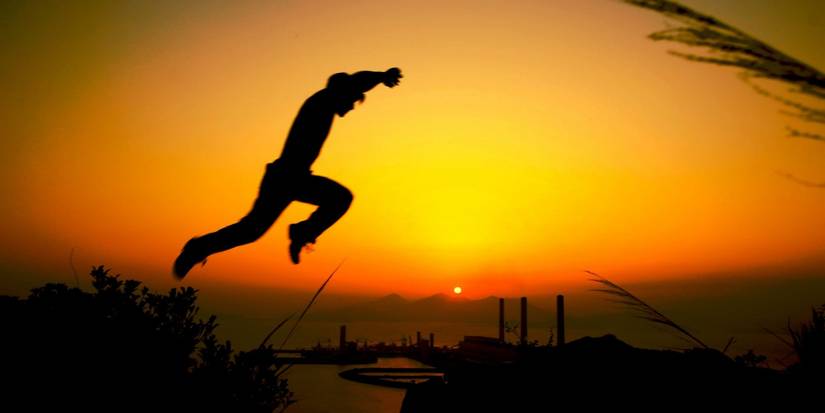 The main character of Yamakasi makes a leap at sunset