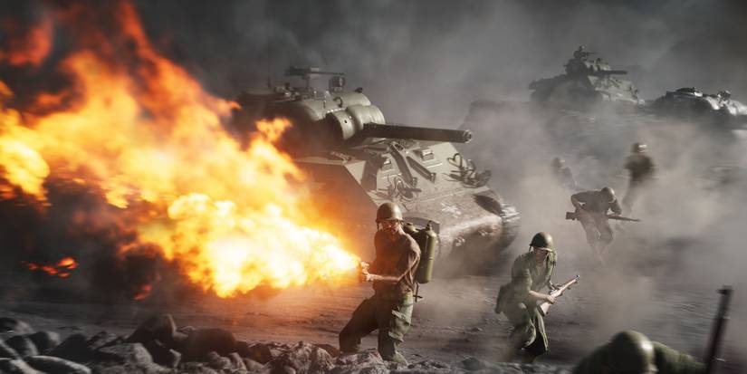 battlefield 5 character using a flame thrower with a tank emergin the background 