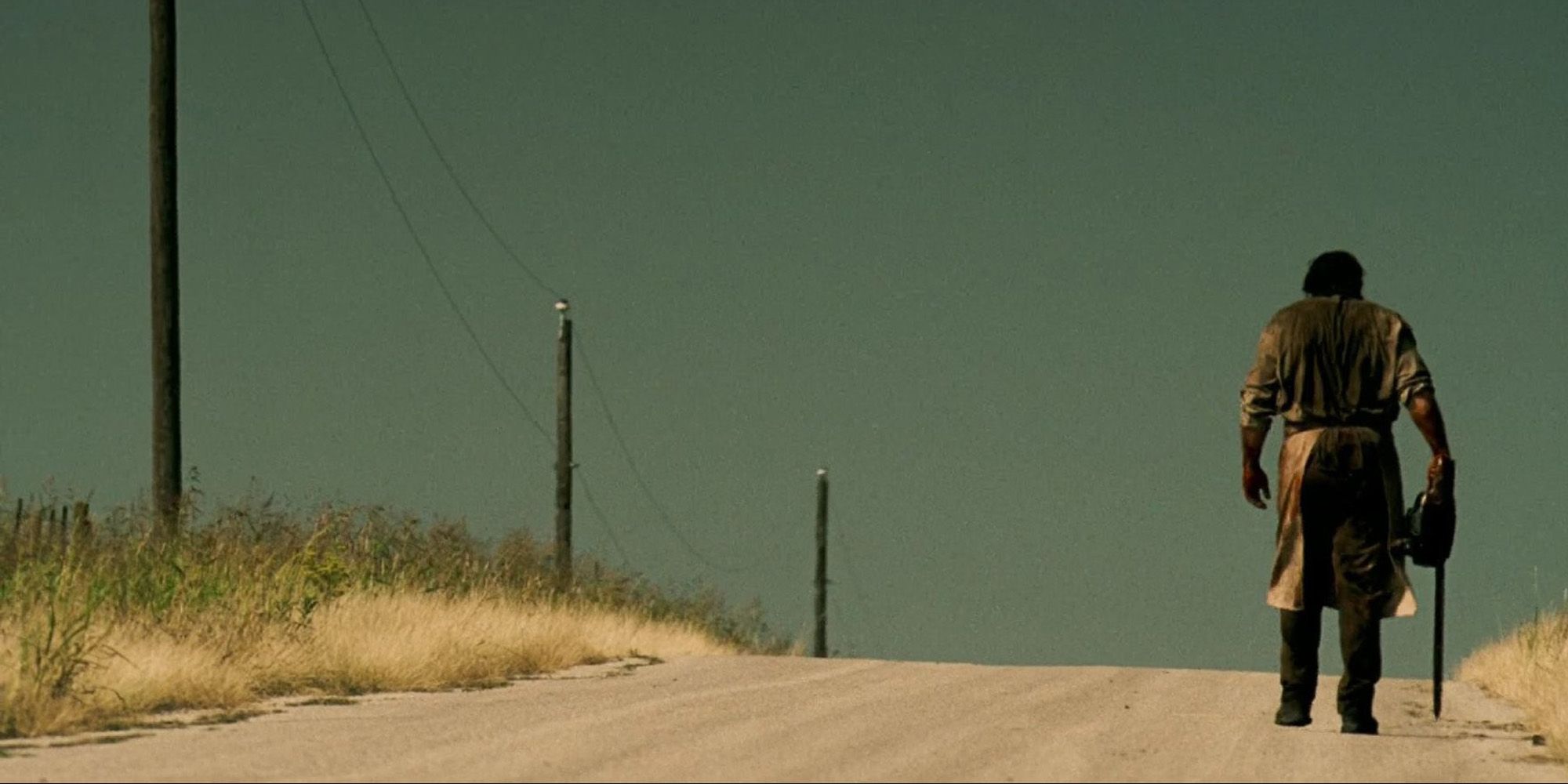 texas chainsaw massacre killer walking down a road