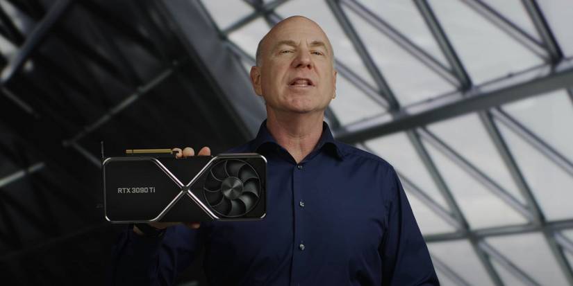 Photo showing someone holding up an Nvidia RTX 3090 Ti graphics card.
