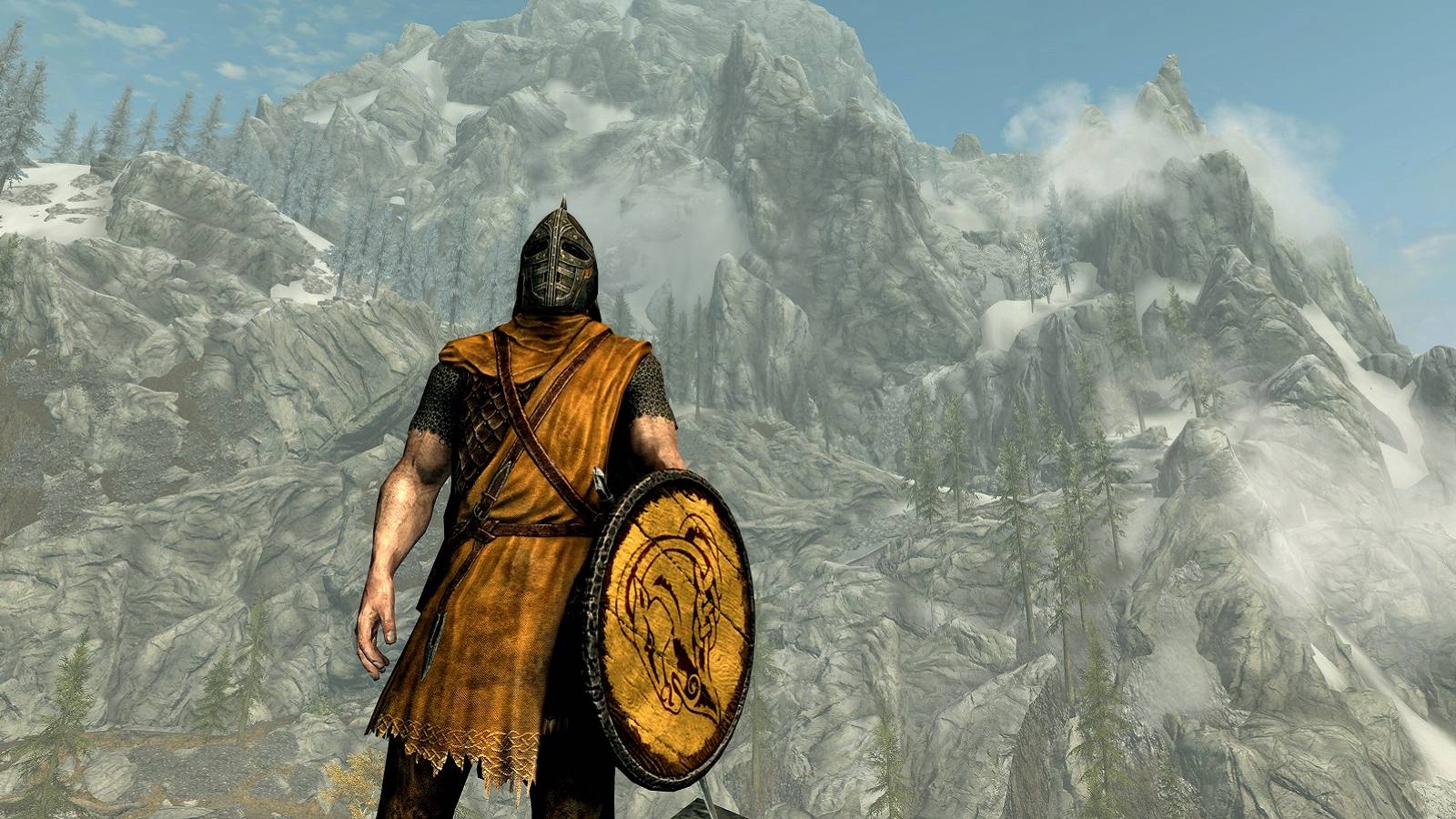 Image from Skyrim showing a guard in the foreground with the Throat of the World mountain in the background.