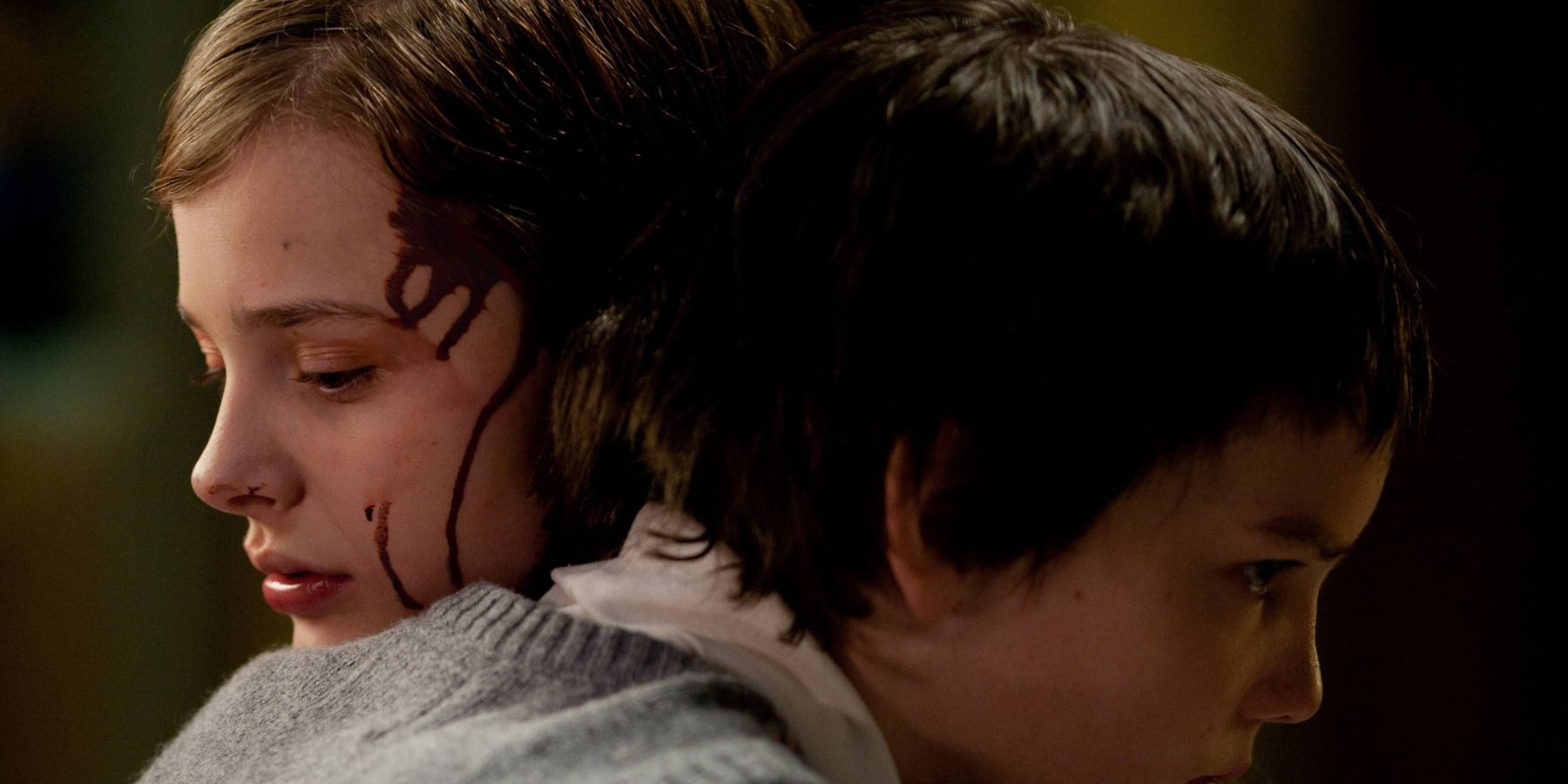 Abby (Chloe Grace Moretz) And Owen (Kodi Smit-McPhee) hugging in Let Me In