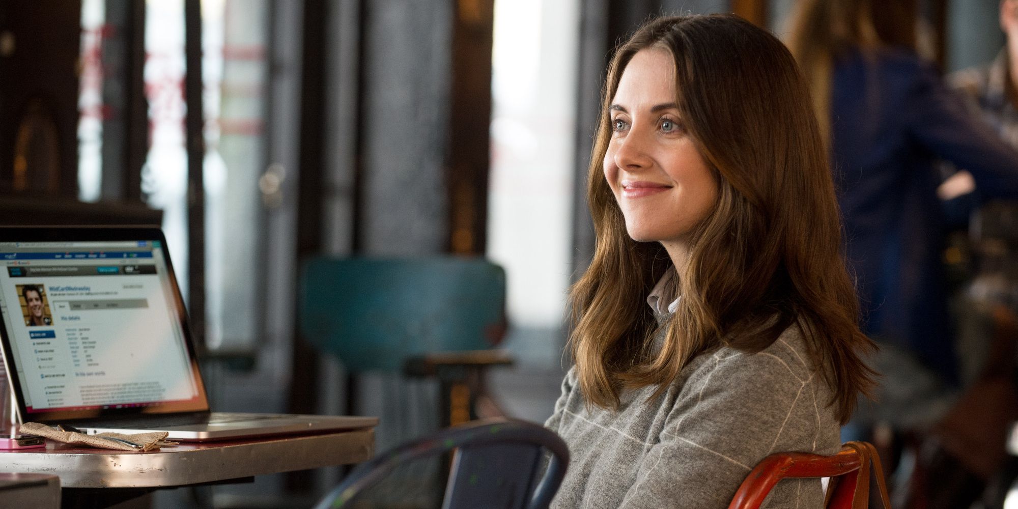 Alison Brie sitting at a computer in How To Be Single