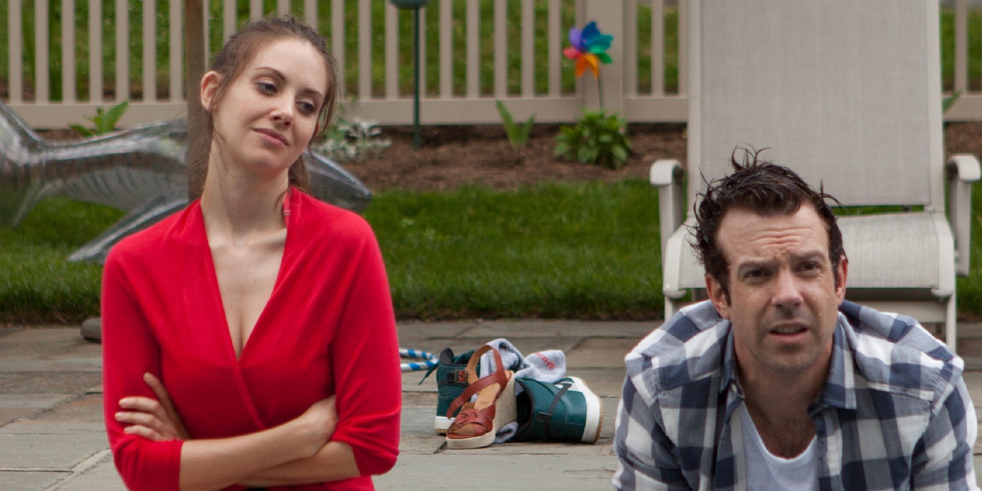 Alison Brie sitting by a pool with Jason Sudeikis in Sleeping With Other People