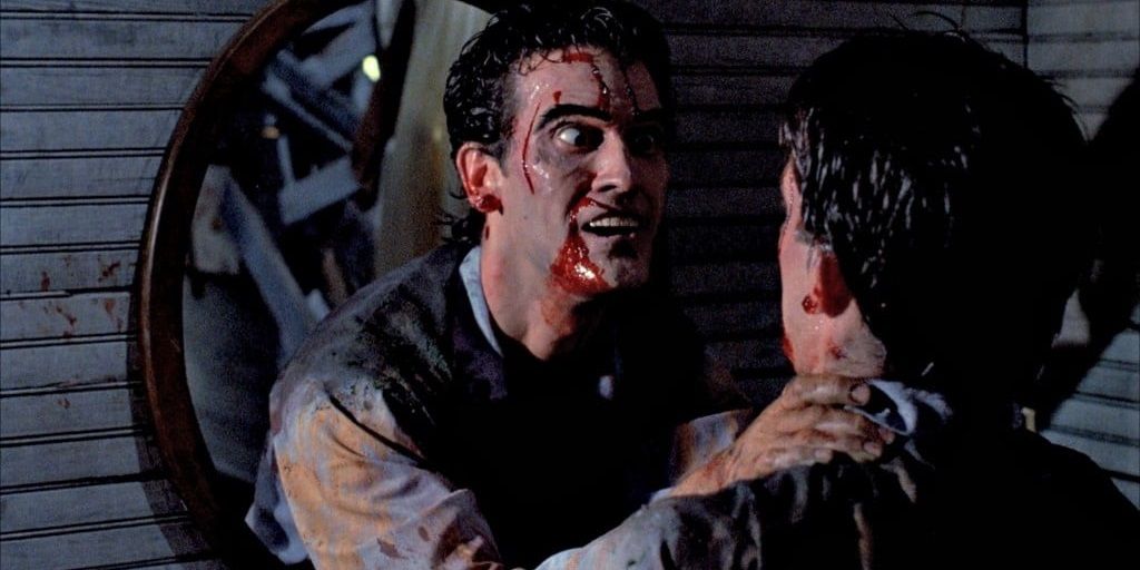 Ash lunges at himself through a mirror in Evil Dead II