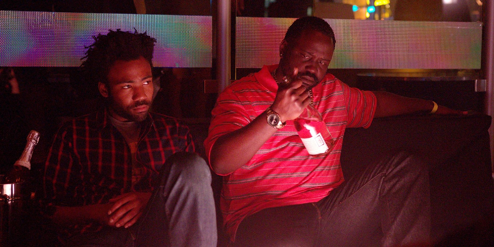 Atlanta Earn and Alfred sitting in a nightclub