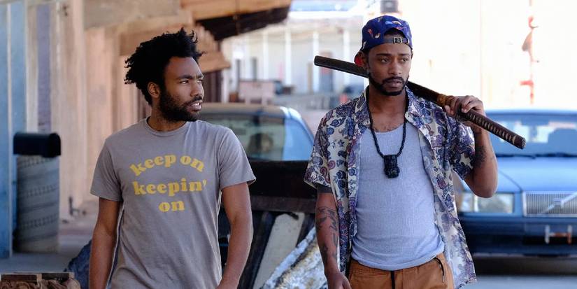 Atlanta Earn walking alongside Darius, who holds a katana sword