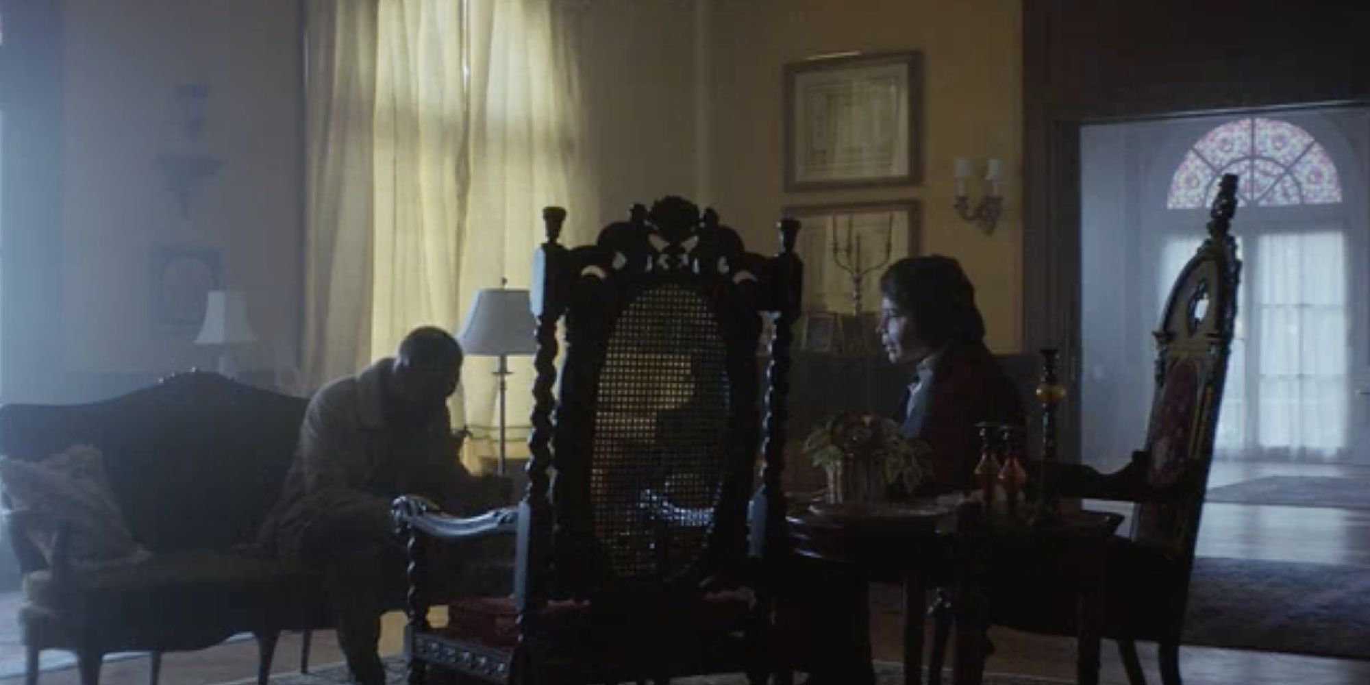 Atlanta Darius sitting across from Teddy Perkins in the dark mansion
