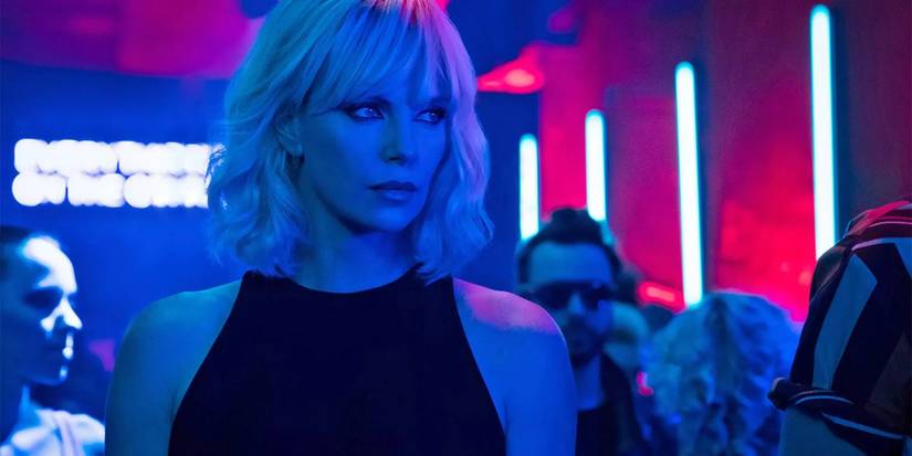Lorraine Broughton walking through a neon nightclub in Atomic Blonde