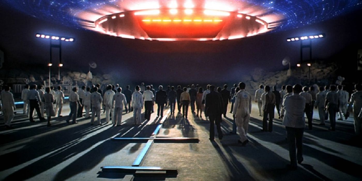 Humans in front of the alien ship