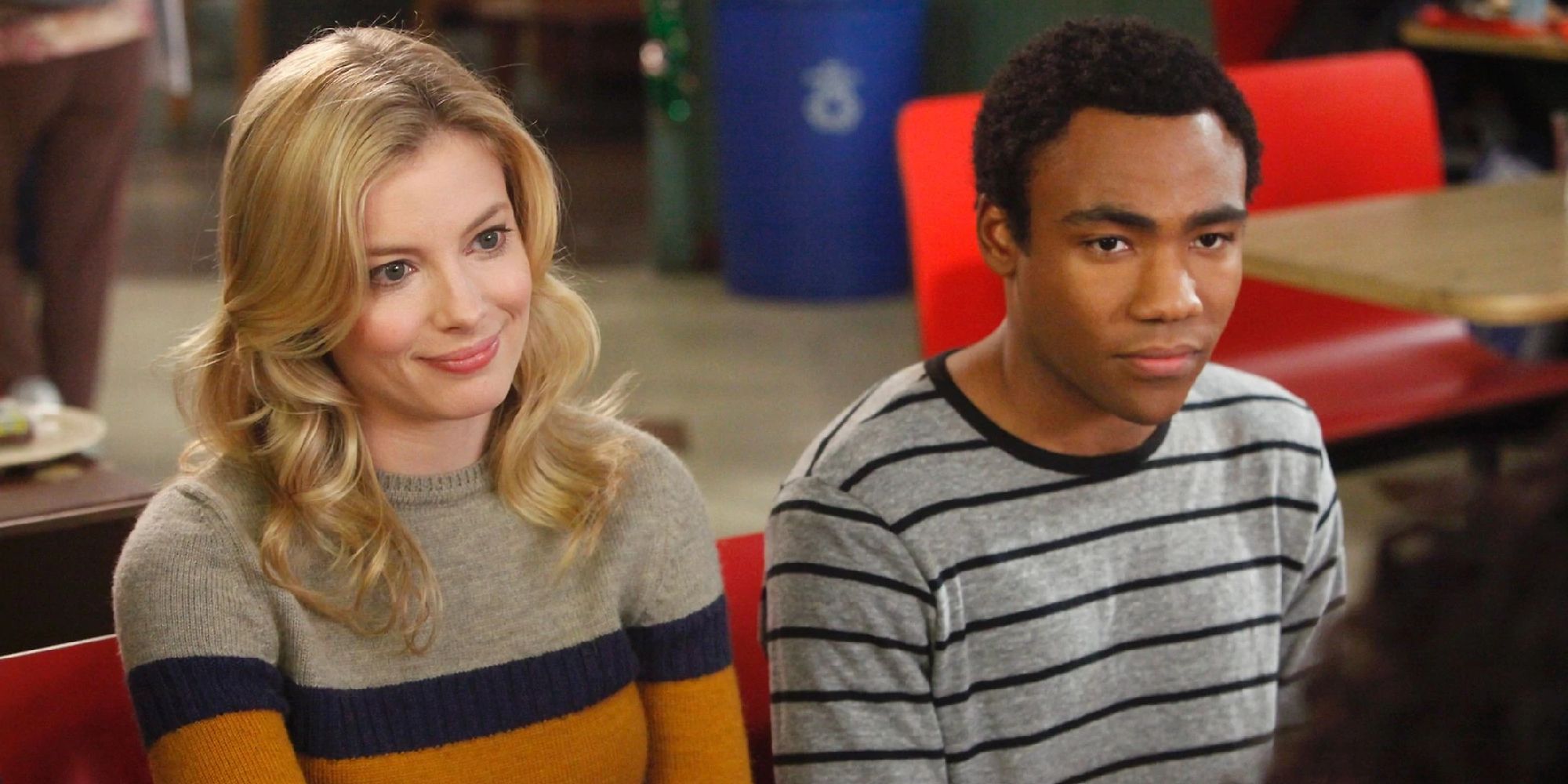 Donald Glover as Troy sitting next to Gillian Jacobs as Britta in Greendale's cafeteria on Community