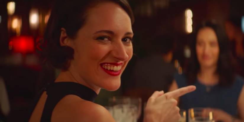 Fleabag talking to the camera while pointing at her family, including Sian Clifford as Claire
