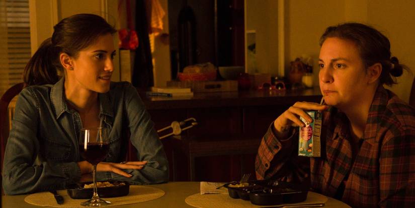 Marnie having wine and Hannah having a juice box during dinner 