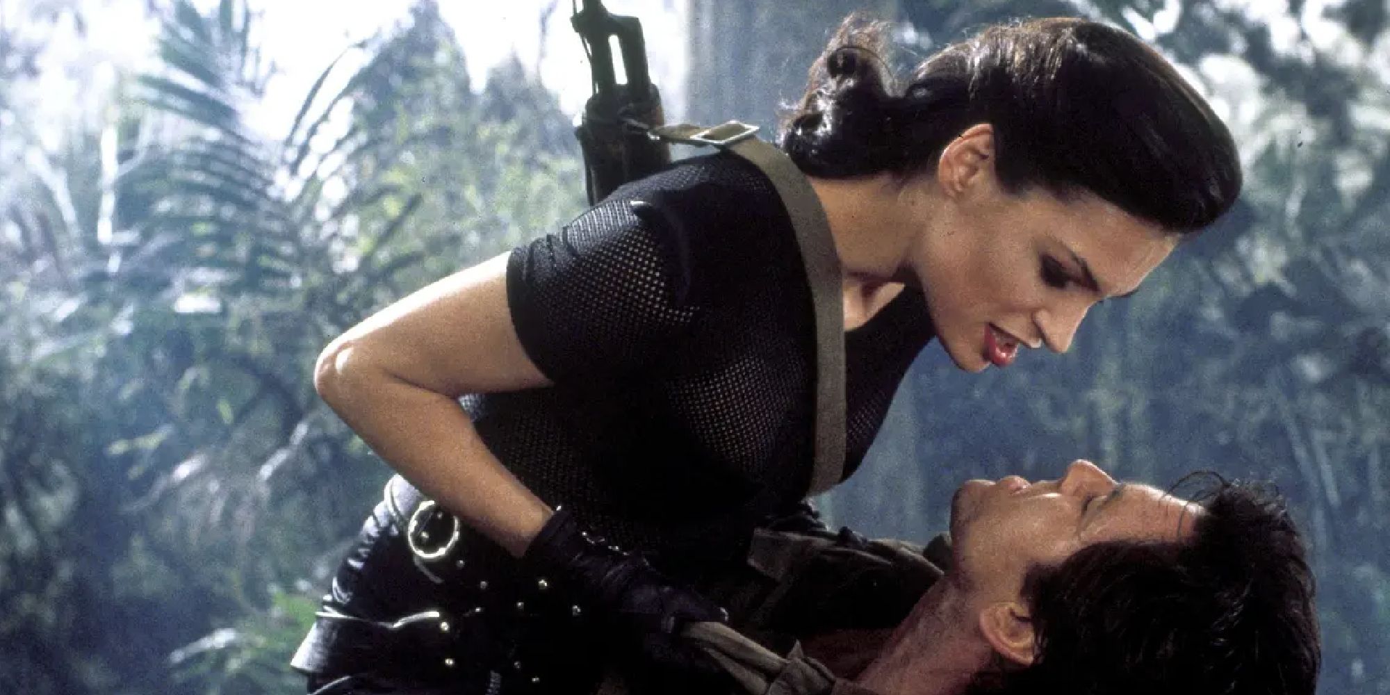 Xenia Onatopp pinning down James Bond in a jungle in GoldenEye