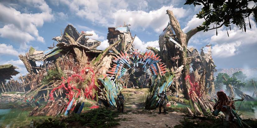 a town made up of logs and colored metal plates set over a shallow pool of water