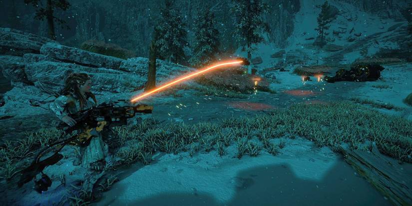 aloy standing in a snowy field at a night, holding a large gun that's firing a disc-shaped projectile toward a group of more, hovering disc projectiles 