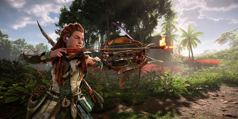 aloy in a green and white outfit holding a small, flat bow with a flame-tipped arrow knocked